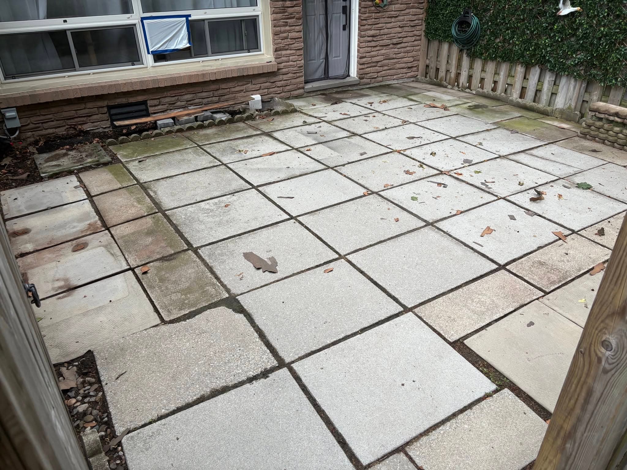 Old cracked and stained concrete patio before Welbanks rebuild