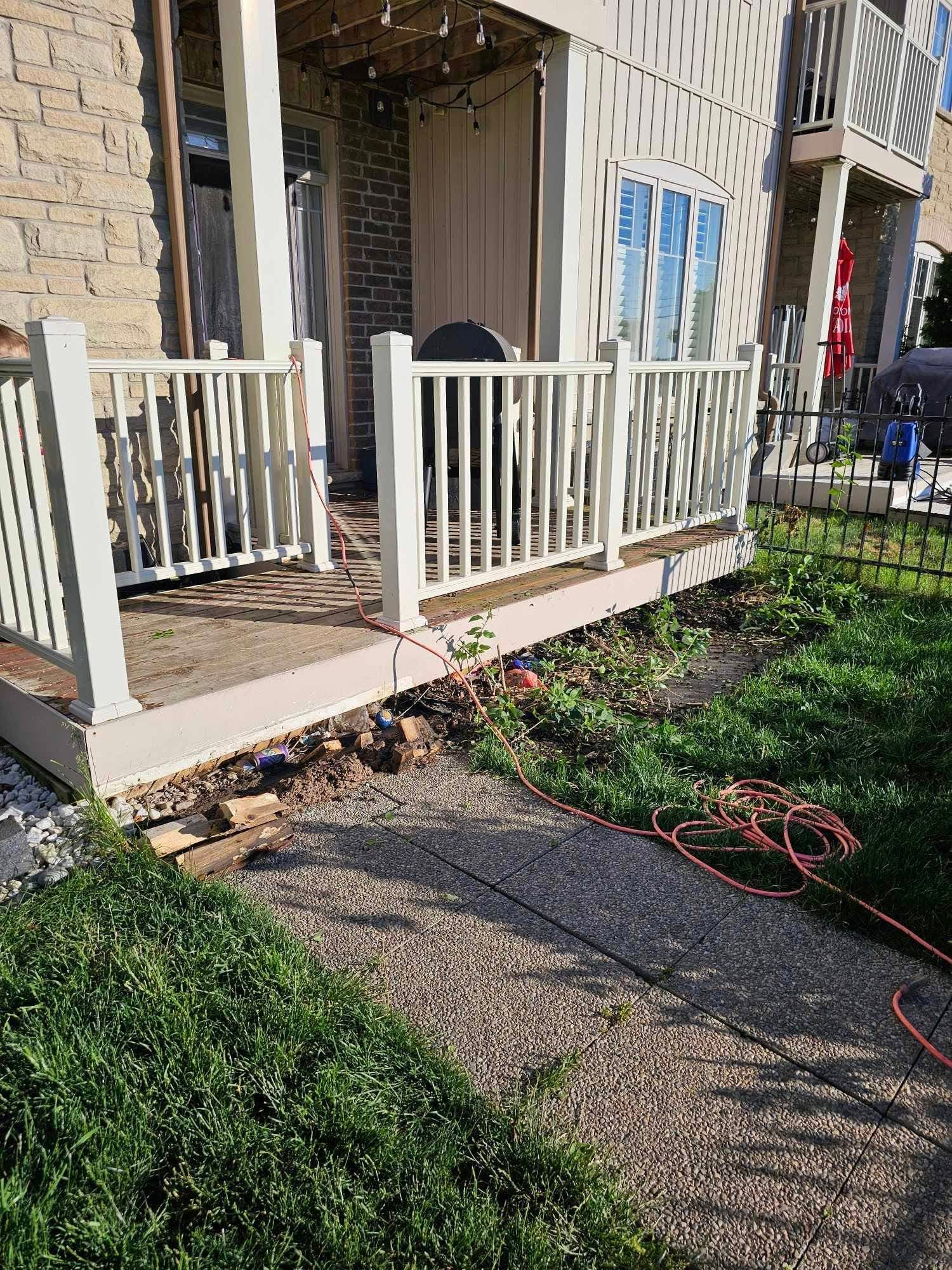 Front porch deck mid-construction with materials on site